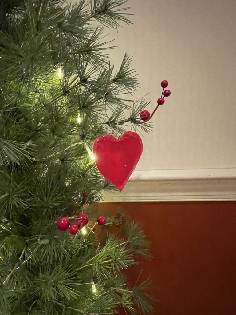 Ornament Symbol or A Heart hanging from a Christmas tree symbolizing God's love to send Jesus as Immanuel, God With Us