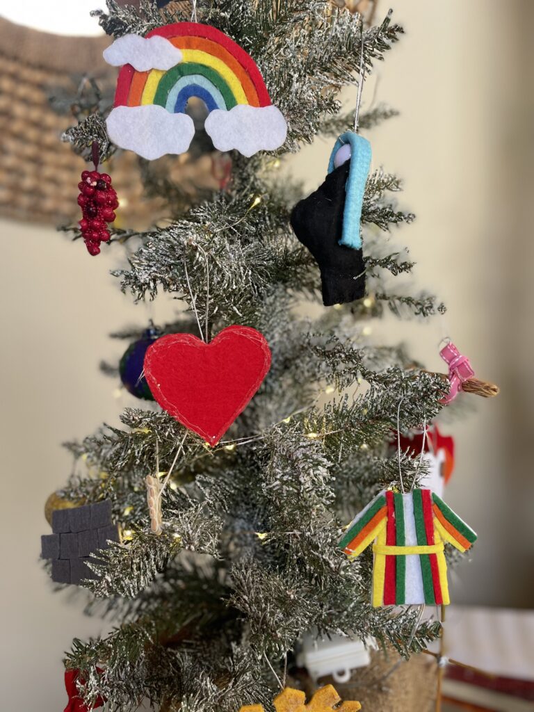 A Christmas Tree decorated with ornaments symbolizing various stories in the Bible